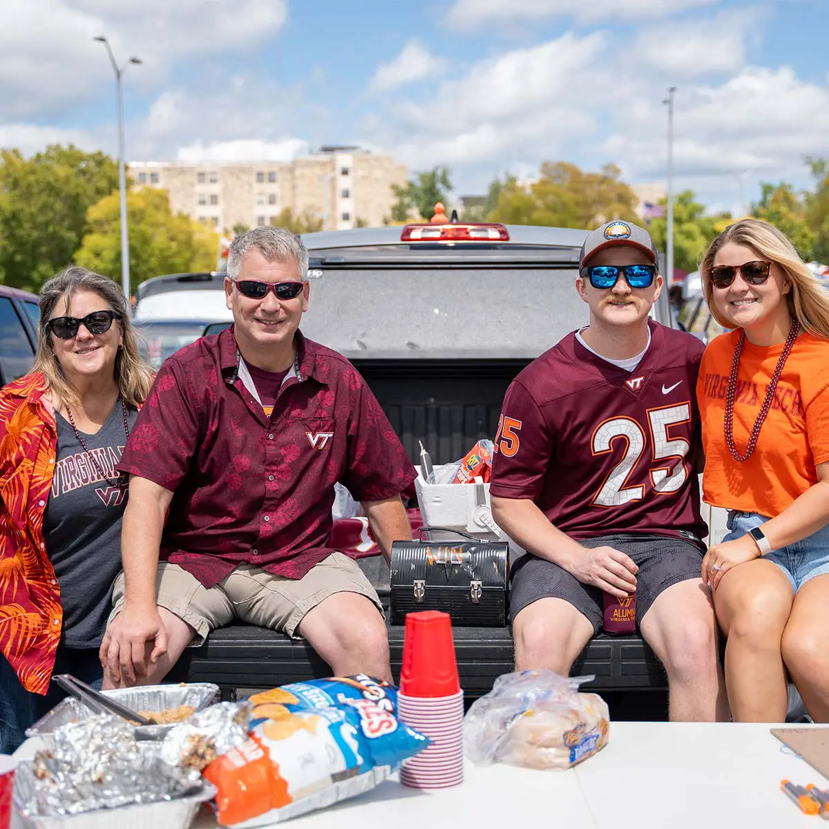 fans posing for photo on back of pickup truck