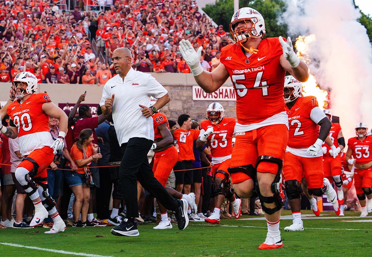 Football players running onto field